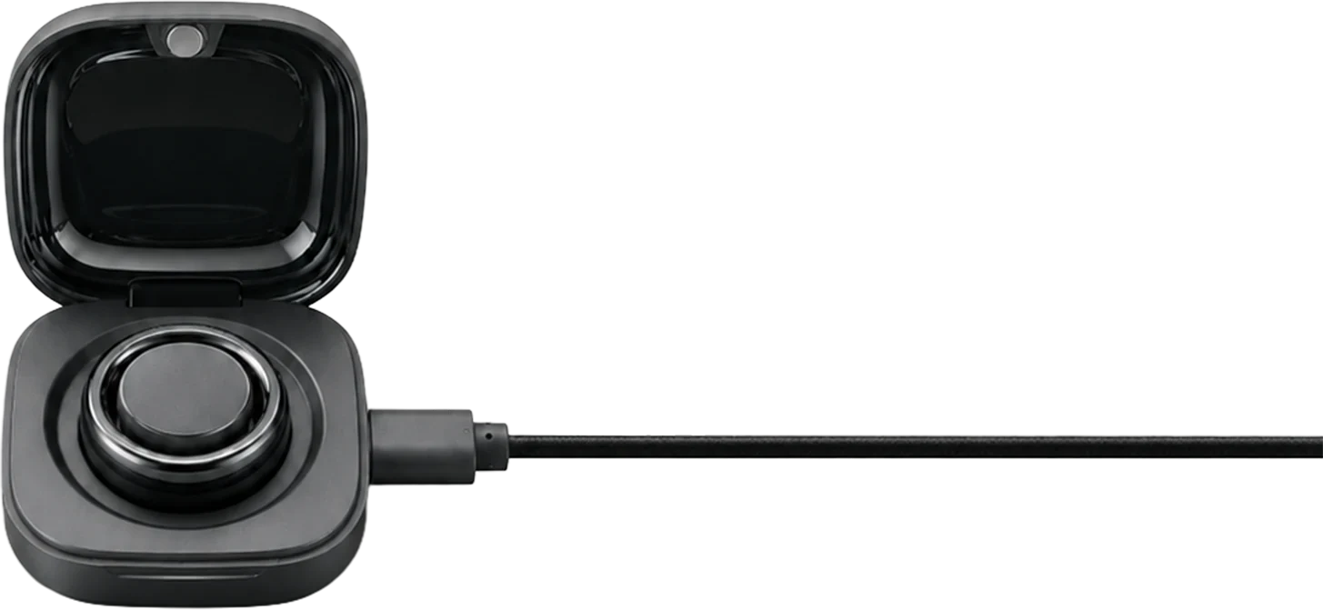 The PhenomeTech Ring seated in its magnetic charging dock, lid open, with the charging cable running out of the frame