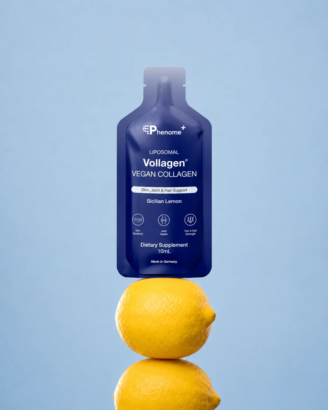 A sachet of Phenome+ Liposomal Vollagen balanced on two lemons