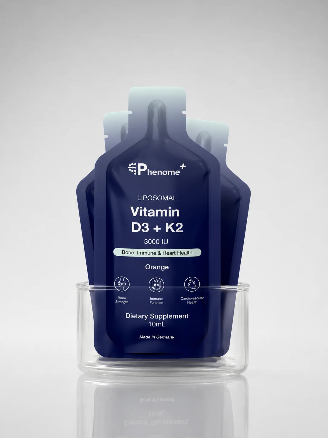 Sachets of Phenome+ Liposomal Vitamin D3+K2 standing in a glass